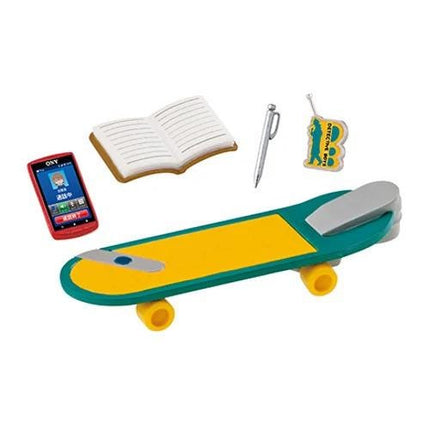 a skateboard, a book, a pen, and a cell phone.