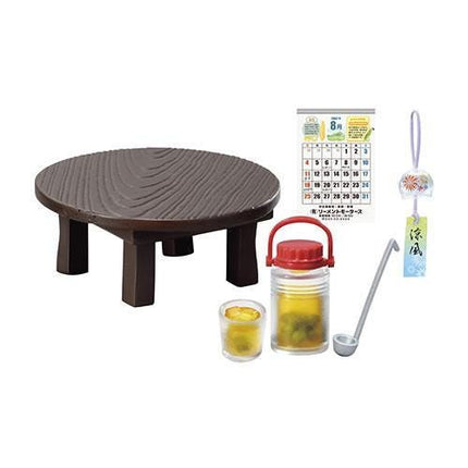 a wooden table, a calendar, a lantern, a cup, and a spoon.