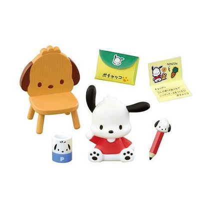 various small toys and items, including a wooden chair, a small white dog figurine, a yellow envelope, a red pencil, and a blue and white container with a black and white dog design.
