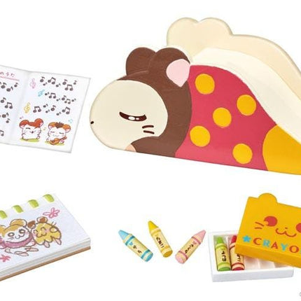 various children's toys and items, including a toy slide, a book, crayons, and a box.