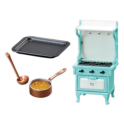 a miniature kitchen set, including a blue stove, a black baking tray, a copper pot, and a small white oven.