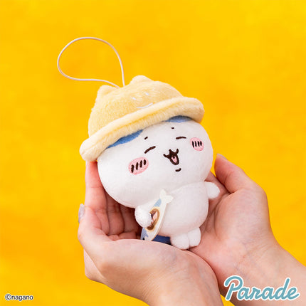 Autumn mascot plush keychain side view, yellow cap, white face, small blue detail.