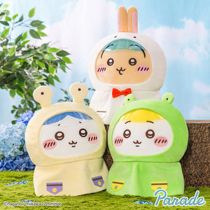 Three hooded plush toys with cute faces: cream, green, and light tan, each with tiny paws