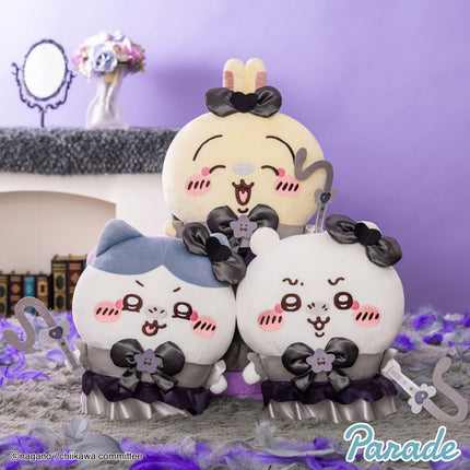 Panda-like plush toy pair with black bows, purple ruffle skirts, and white faces
