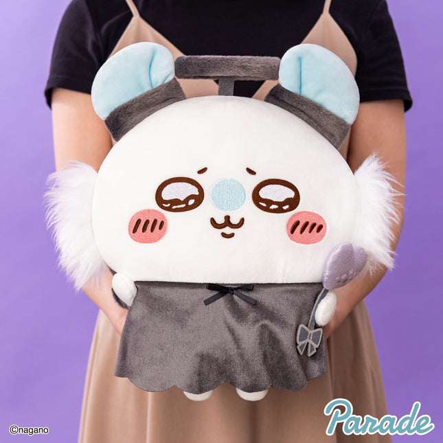 Big plush toy panda with blue ear pads and gray dress, front view