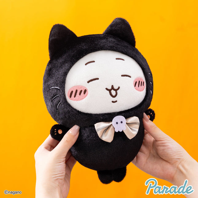 Black cat plush toy close-up, holding pose, white bow tie