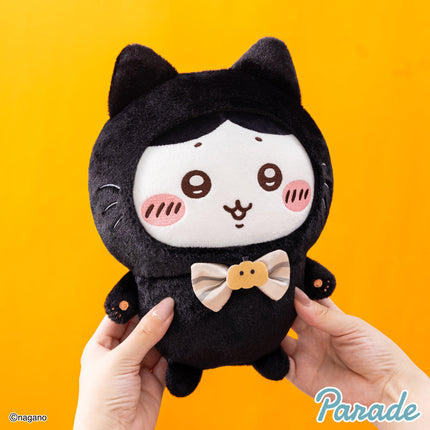 Black cat plush toy with tan pumpkin-style bow tie detail