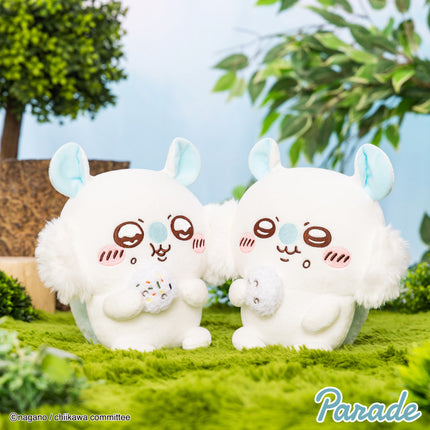 Two white plush toys with blue ears, brown faces, each holding a small squirrel plush