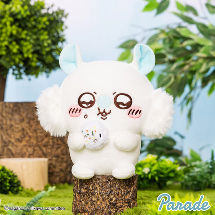 White plush toy with blue ears, brown face, and small squirrel plush in front