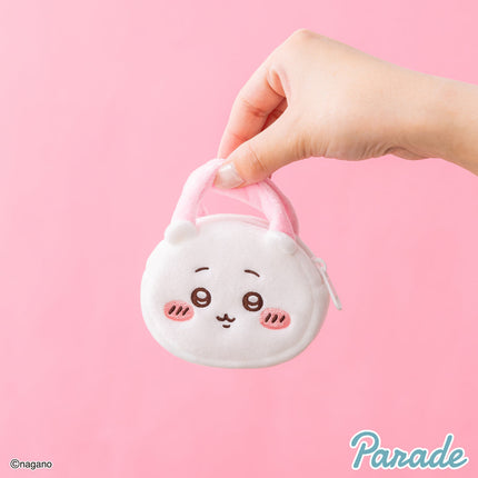 Plush mini tote bag held in hand, white face with loop handle
