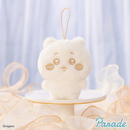 Milk-colored plush mascot keychain with stitched face, wearing a loop strap