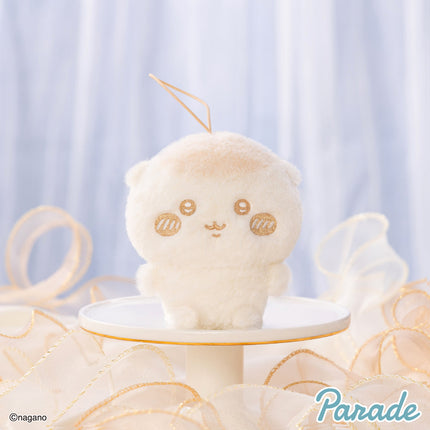 Milk-colored plush mascot keychain with loop strap and stitched face, side view
