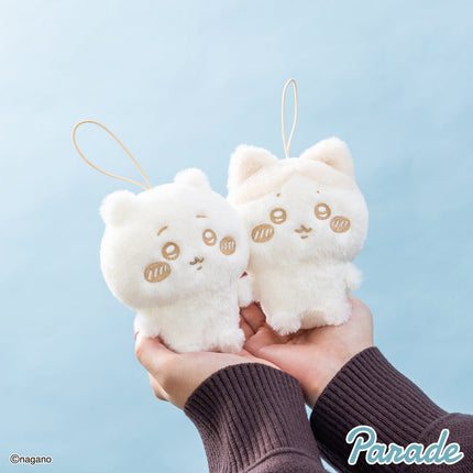 Milk-colored plush mascot pair with loop straps held in hands, stitched faces
