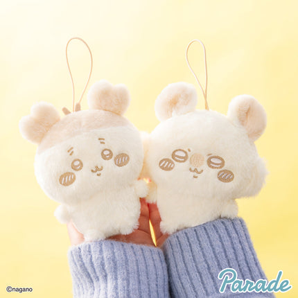 Pair of light cream plush mascots with long ears wearing blue striped sleeves