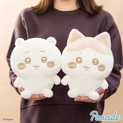 Milk-color cat plush toys held in hands, showing embroidered faces and ears