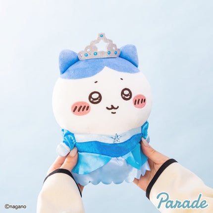 Princess birthday plush toy held in hand, wearing a blue ruffle dress and crown