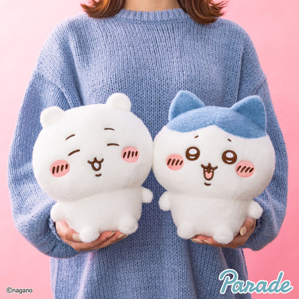 Super fluffy plush toy pair held in hands: white bear-faced plush and white plush with blue ears