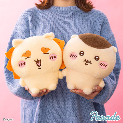 Super fluffy plush toy pair held in hands: cream plush with orange tuft and cream plush with brown patch