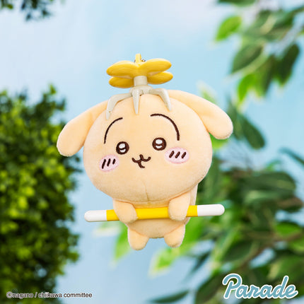 Plush mascot keychain, tan character with yellow outfit and small sword-like prop