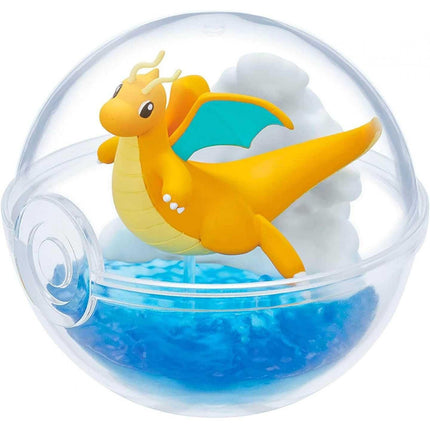 A figurine of a dragon-like creature with yellow and blue colors, resembling a Pokémon or similar Pokémon character, is depicted inside a transparent ball-shaped container filled with blue water.