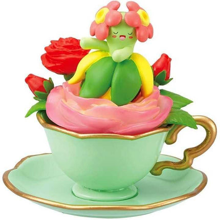 A figurine of a flower in a teacup, with a teacup and saucer.