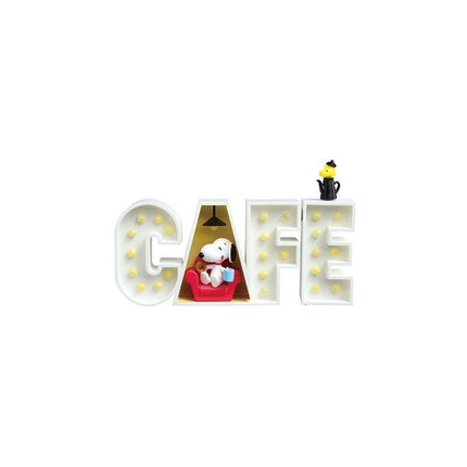 A lighted sign spelling out "CAFÉ" with a small dog figurine inside the letter "C".