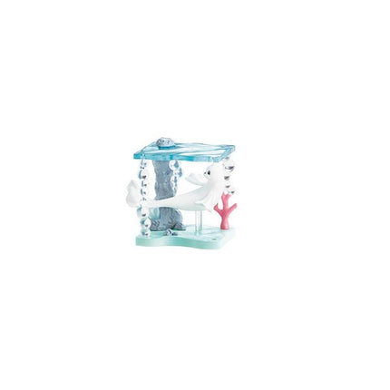 A small toy figurine of a white bird sitting on a blue platform with a pink coral piece.