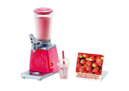 A pink blender with a clear plastic cup and a red and white sign featuring a picture of strawberries.