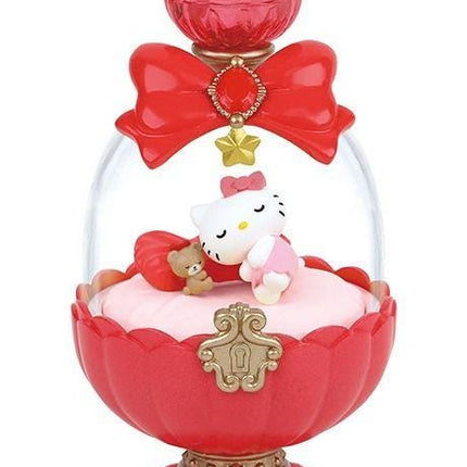 A Hello Kitty perfume bottle with a red and gold design, featuring a sleeping Hello Kitty doll inside a glass dome.