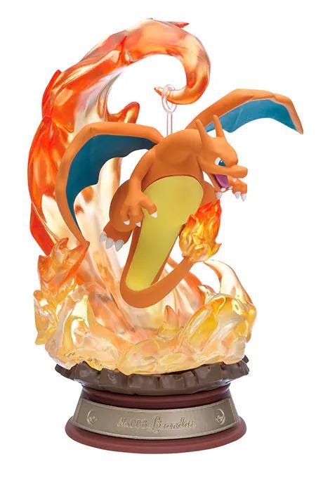 A figurine of a dragon-like creature with orange and yellow colors, surrounded by flames and smoke, mounted on a base.