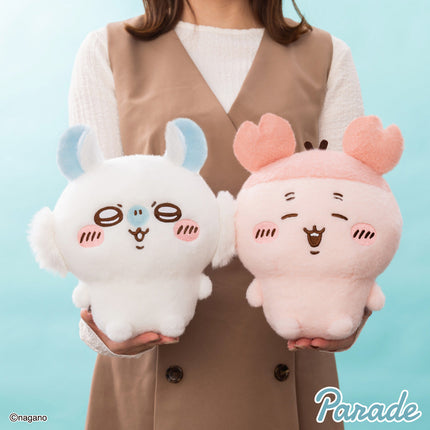 Super fluffy plush toy pair held in hands: white plush with blue ears and white plush with pink ears