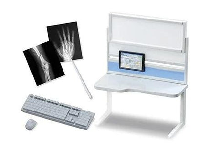 a computer desk with a monitor, keyboard, mouse, and two X-ray images.