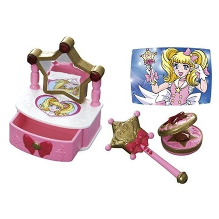 a pink and gold vanity set with a mirror, a pink and gold wand, and a pink and gold makeup compact. There is also a picture of a girl with blonde hair and a pink dress.