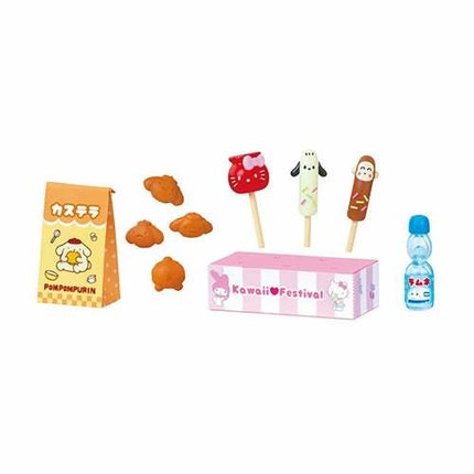 various food items and a bottle, including a bag of popcorn, a box of Hello Kitty candy, and a bottle of water.
