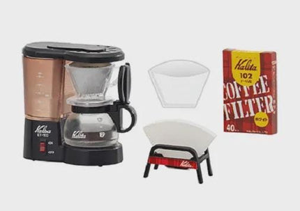 a coffee maker, a coffee filter, and a box of coffee filters.
