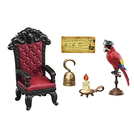a red chair, a gold bell, a candle, and a parrot statue, all arranged in a decorative manner.