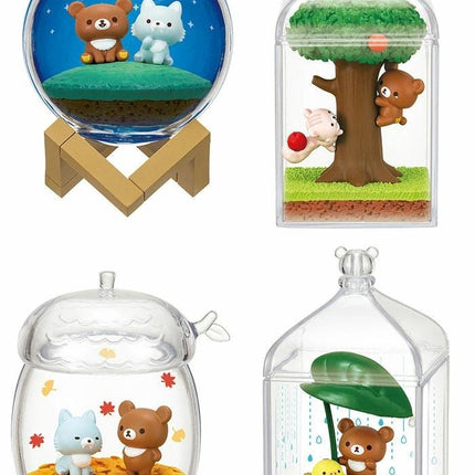 four different miniature figurines or scenes, each displayed in a unique container or setting.
