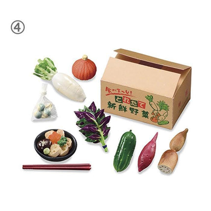 various food items, including a cardboard box, a bowl of food, a pair of chopsticks, and several vegetables such as a carrot, a radish, and a cabbage.