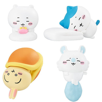 Four chibi sleeping mascot capsule toys: white cat with pink mug, blue-hat, orange hood, blue body