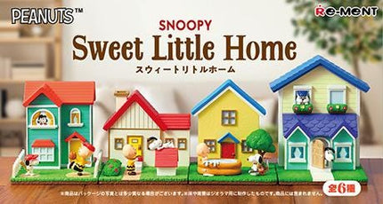 a wooden table topped with small toy houses