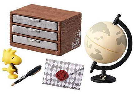 a Peanuts themed miniature set, including a wooden drawer, a globe, a pen, an envelope, and a Snoopy figurine.