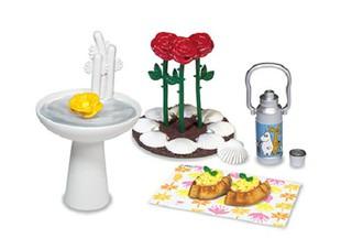 various objects, including a white sink, a yellow flower, a silver thermos, a plate with food, and a small vase with flowers.