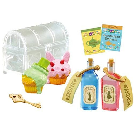 various objects, including a clear plastic chest, two bottles of liquid, a key, a cupcake, and a book.
