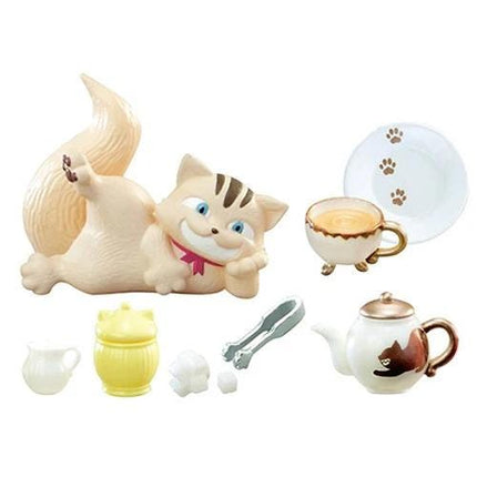 A collection of various tea-related items, including a cat figurine, a teapot, a teacup, and other accessories, arranged on a white background.