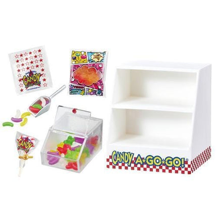 various candy-related items, including a candy display case, a bag of candy, and a container filled with candy.