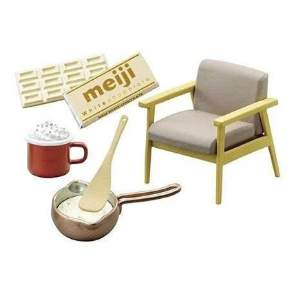 various objects, including a chair, a mug, a spoon, a chocolate bar, and a pot.
