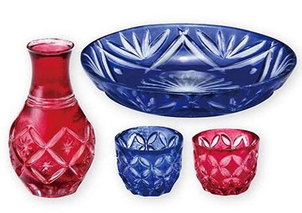 A collection of four crystal-like glass containers in various colors, including red, blue, and pink, arranged in a row.