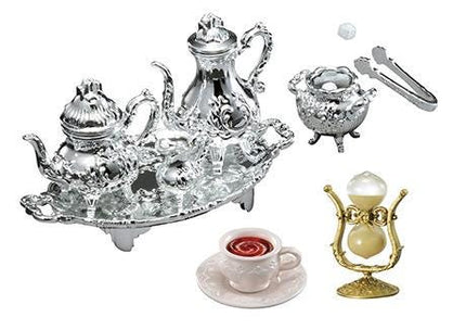 a variety of ornate, antique-style tea set pieces, including a silver teapot, a silver sugar bowl, a silver teacup, and a silver candlestick holder.