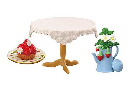 a table with a lace tablecloth, a plate with strawberries, a teapot with a flower arrangement, and a small cake.
