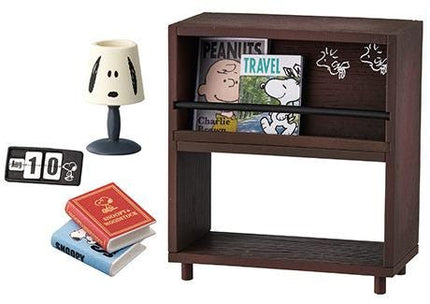 a Peanuts-themed miniature set, including a Peanuts-themed lamp, a Peanuts-themed book, and a Peanuts-themed magazine.